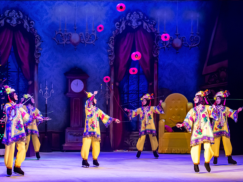 Girls in chinese costumes throwing diabolos. The Nutcracker by Moscow circus on ice